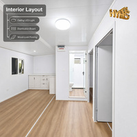 Maison conteneur préfabriquée moderne de 20 pieds, cadre blanc, grain de bois 3D, double ailes, toit incliné, appartement, villa extérieure, usage hôtelier, garantie 5 ans