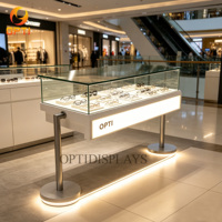 Mostrador de Exhibición para Óptica de Lujo Moderno con Patas Metálicas Minimalistas y Vitrina para Gafas con Iluminación LED