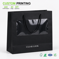 Sac en papier noir imprimé sur mesure avec fenêtre transparente et poignée en cordon noir pour l'emballage cadeau des boutiques et des magasins de détail, vente en gros