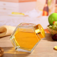 Bocaux en verre hexagonaux de haute qualité de 100 ml, 220 ml et 380 ml avec couvercles en bois pour le stockage du miel, des bonbons et du sucre