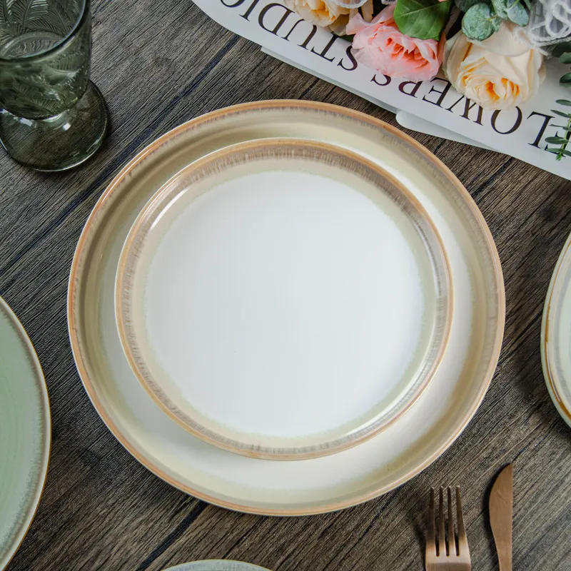 Set di piatti da tavola in porcellana moderna dipinta a mano stoviglie Set di glassa rotonda reattiva piatti in ceramica e piatti per ristorante