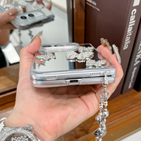 Étui de luxe 3D papillon en strass avec miroir pour iPhone Duo Fold 18, chaîne de poignet en cristal, maquillage, antichoc, personnalisé
