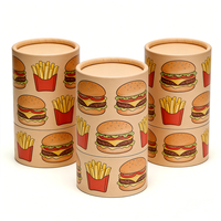 Emballage en tube cylindrique en carton écologique fait main à motif burger et frites, avec matériaux recyclés pour la restauration rapide et les collations