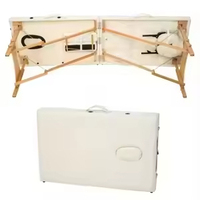 Table de massage pliable portable en cuir synthétique moderne de haute qualité, confortable et durable, idéale pour les salons de beauté, les spas et les massages thaïlandais.