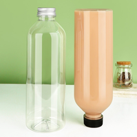 Bouteilles de boisson rondes transparentes en PET de 1000 ml (32 oz) avec bouchons à vis pour boissons énergisantes, café, vodka et bière - 50 pièces/carton