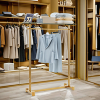 Table et étagères de présentation de vêtements pliables en acier inoxydable doré brillant CAIYI XG19 au design moderne