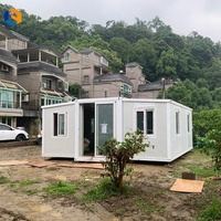 Maison conteneur extensible à double aile utilisée pour le transport de fournitures de secours et transformée en abris temporaires