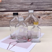 Bouteille en verre transparente vide pour liqueur, bouteille en verre ronde plate pour jus, emballage de bouteille avec logo imprimé personnalisé, vente en gros