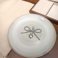 Porte-clés délicat nœud et cœur - Breloque de sac minimaliste en argent pour usage quotidien et décoration de sac
