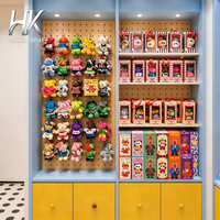 Vitrine murale en bois bleu sur mesure avec étagères en verre, comptoir d'îlot et éclairage LED pour magasin de jouets