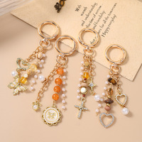 Nouveau porte-clés rond en alliage, breloque de sac en forme de croix, perles, papillon, cœur, très vendu