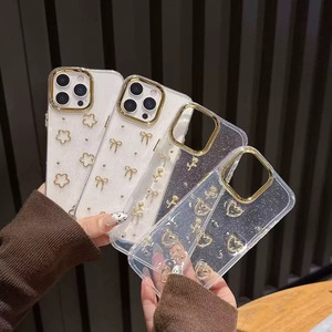 เคสโทรศัพท์ที่เหมาะสำหรับ iPhone 17 Pro Max, เรซิ่นกลิตเตอร์, โบว์ทองเรียบง่ายและรูปหัวใจ, เคสโทรศัพท์กันกระแทกแบบนุ่ม - Product Image 1