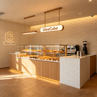 Airy Luxe Bakery & Coffee Market Stall Featuring Glass Display Case, Open Tiered Shelving, and Integrated Warm Lighting