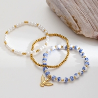 Bijoux délicats en acier inoxydable plaqué or 18 carats chaîne perlée perles en céramique perle Pigeon breloques couche bracelet pour femmes