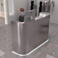 Bureau d'accueil au design incurvé avec finition métallique, comptoir personnalisé, mobilier commercial moderne pour salon, spa, hôtel, commerce de détail