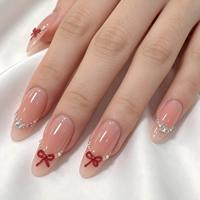 Faux ongles à presser en amande, nude transparent, avec nœud rouge 3D, ligne de perles et gemmes émeraude argentées, finition brillante, vente en gros, personnalisables, marque privée