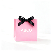 Sacs à provisions en papier noir mat de luxe Logo imprimé personnalisé avec poignée en ruban pour l'emballage de bougies-Manutention de la stratification