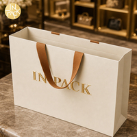 Sacs cadeaux de luxe personnalisés avec gaufrage et marquage à chaud du logo, sacs en papier pour le shopping, sacs de vente au détail entièrement imprimés avec poignée dissimulée