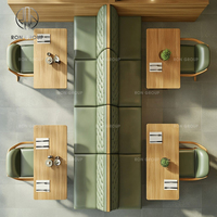 Ensemble de meubles pour café, restaurant, salon de thé : fauteuils en cuir vert avec pieds en bois, tables rectangulaires en bois et canapé banquette vert.