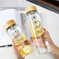 Bouteille d'eau transparente en verre borosilicate naturel moderne de 16 oz et 35 oz avec couvercles en bambou pour les voyages et le camping