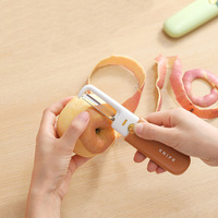 OEM Nouveau design tendance 2 en 1 Éplucheur de fruits et racloir à melon multifonctionnel en acier inoxydable, râpe de cuisine polyvalente avec PP