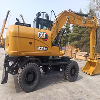 Excavatrice mobile sur roues CAT M315GC de haute qualité, 15 tonnes |   Profondeur de creusement de 4,62 m |   Rénovation de communautés résidentielles |   Offre à Durée Limitée