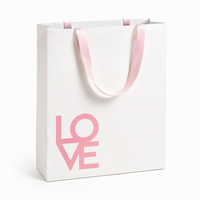 Sac en papier blanc personnalisé avec poignées en ruban rose et face imprimée pour emballage cadeau de détail, acheteurs en gros