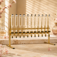 Distributeur de parfum manuel de luxe, machine de remplissage et de présentation de liquides en verre à 12 têtes multiples