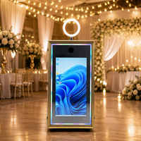 Photomaton intégré dans un cabinet, style borne interactive, avec éclairage RGB et imprimante dissimulée, idéal pour les événements commerciaux
