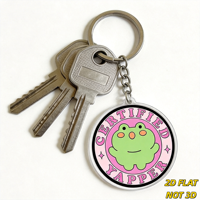 Portachiavi Certificato Yapper Frog, simpatico rospo verde su cerchio rosa, accessorio divertente per amanti dei chat, per borse, chiavi, zaini