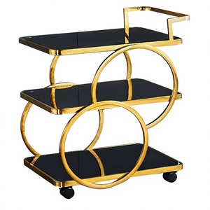 Chariot de bar moderne à trois niveaux avec roulettes, plateau en verre noir, structure en métal doré, étagère de rangement pour le service de boissons dans le salon - Product Image 4