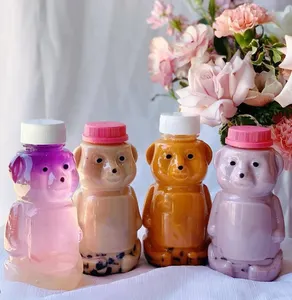 Nouvelles bouteilles de jus en plastique de 2 oz Bear paquet de boissons pour enfants bouteille de 60ml avec bouchons de couleur personnalisés