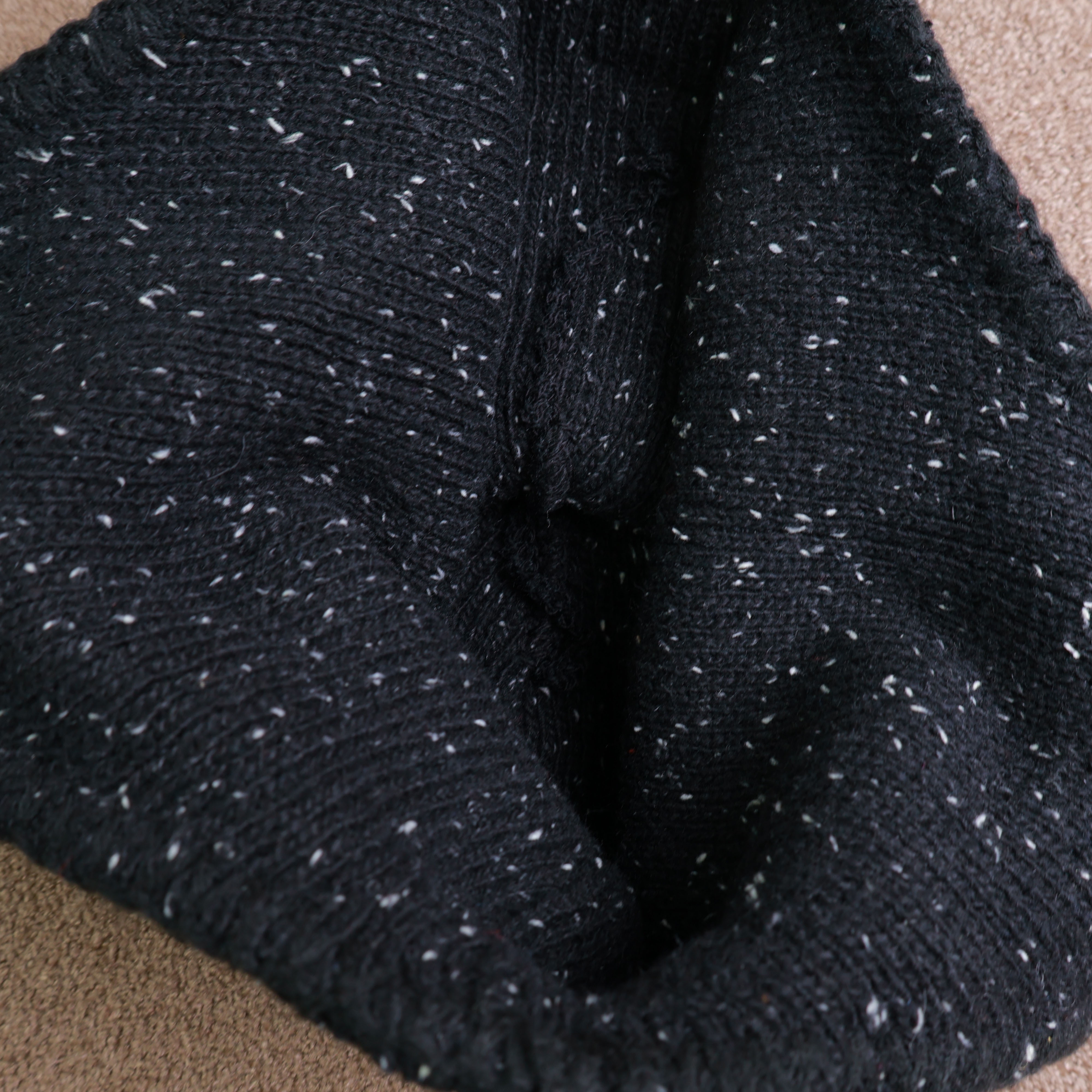 Drawstring closure detail of knitted hat