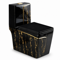 WC monobloc en céramique noire effet marbre, avec décorations dorées pour salle de bain de luxe