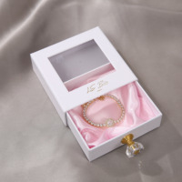 Boîte à bijoux écologique personnalisée avec fenêtre en PVC, en carton et avec poignée en cristal pour l'emballage de colliers, avec logo personnalisé