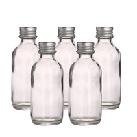 Vente en gros de petites bouteilles rondes vides pour l'emballage d'huile, 2 oz 60 ml, bouteilles en verre pour jus de gingembre avec couvercles