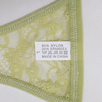 Tanga de encaje antibacteriano de talle bajo sin costuras para mujer con patrón floral bordado de nailon y elastano