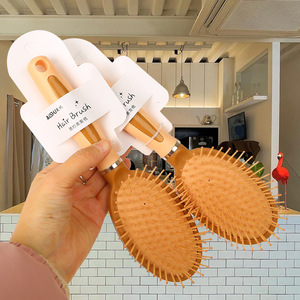 Cepillo para el cabello ovalado de plástico con cojín de masaje para la población en general - Product Image 1