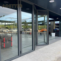Porte pliante en aluminium AOSTTER à cadre noir robuste avec double vitrage isolant et verrouillage multipoints pour une utilisation haut de gamme dans les salles à manger