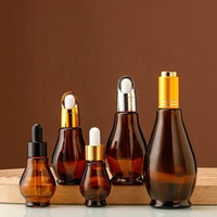 Vente en gros de flacons cosmétiques en verre ambré en forme de gourde de 50 ml, imprimés à l'écran, avec couvercle doré et pulvérisateur à pompe pour le stockage de lotion