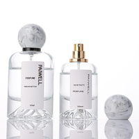 Bouteille de parfum ronde de fond de montagne de volcan de 50ml bouteille en verre de pulvérisateur à sertir vide clair avec couvercle à bille en résine de luxe