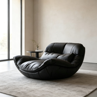 Fauteuil inclinable en cuir noir surdimensionné de style bohème, coque incurvée en fibre de verre, canapé individuel pour un espace intérieur minimaliste