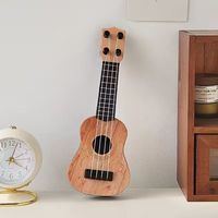 Ornement de bureau en ukulélé moderne Ornement d'instrument de musique pour le salon et la chambre à coucher