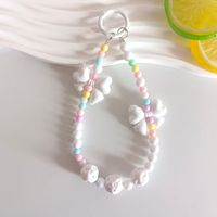 Lanière perlée Macaron Arc-en-ciel avec nœud papillon et breloque fleur rose pour femmes et filles, pendentif de sac en perles acryliques pastel