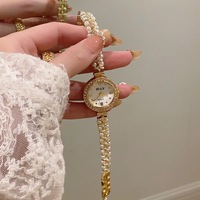 Montre à quartz élégante pour femme, style diamant de luxe, bracelet en alliage incrusté de perles, montre à quartz ronde, vente chaude