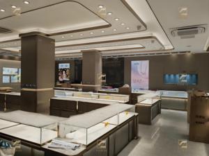 Vendita diretta moderna bronzo spazzolato in acciaio inox vetro temperato gioielli Display da tavolo Design immagini per gioielli vetrina