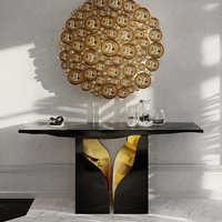 Console contemporaine avec placage laqué noir et finition laiton poli, inspirée des formations karstiques naturelles
