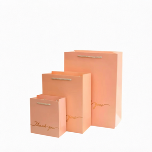 ถุงของขวัญกระดาษพีชเคลือบลามิเนตพิมพ์ลายขอบคุณสีทองพร้อมหูหิ้วเชือกฝ้าย ถุงแบบแบนรีไซเคิลได้สำหรับบรรจุภัณฑ์ของขวัญ - Product Image 1