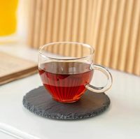Sous-verre rond en grès noir élégant, avec dessus absorbant et base en liège antidérapante, tapis et supports en pierre