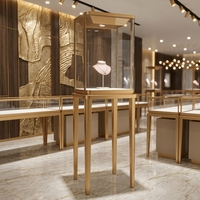 Vitrine à bijoux verticale de luxe en or avec éclairage LED, vitrine moderne en verre trempé pour les magasins de détail